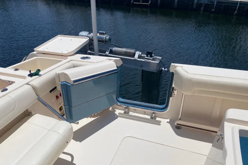 Slide: The Image of 2021 Grady-White Canyon 376 boat interior with open transom door by the water. - 23