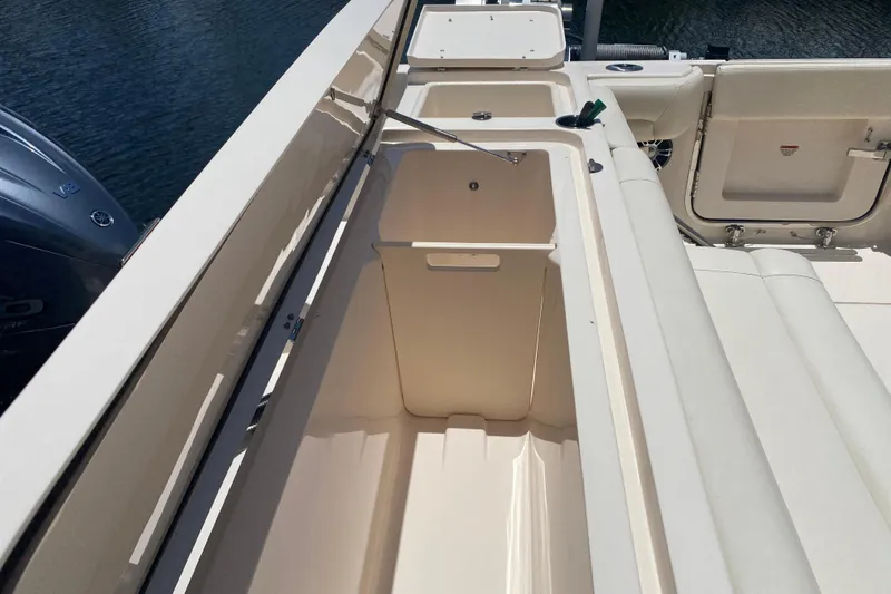 Slide: The Image of 2021 Grady-White Canyon 376 boat interior with storage compartment and seating. - 26