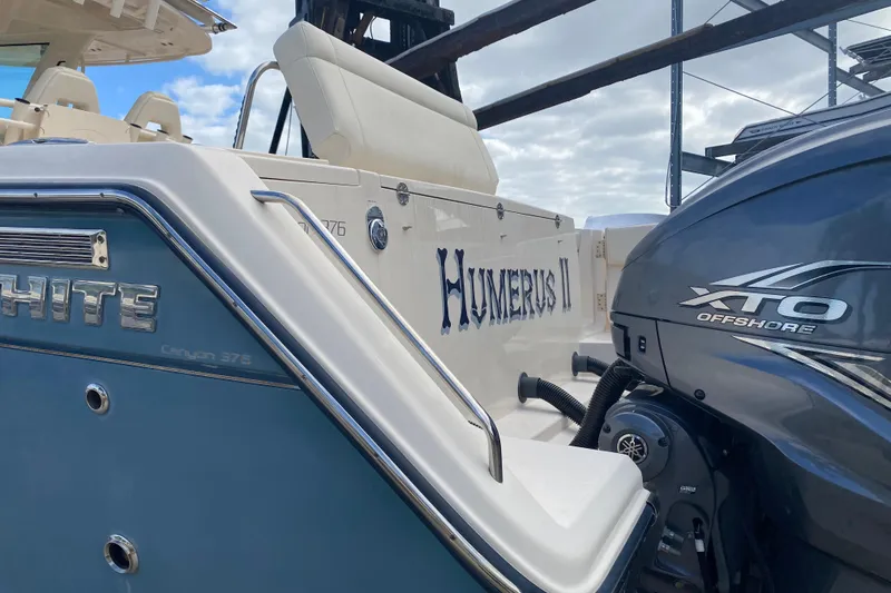 Slide: The Image of 2021 Grady-White Canyon 376 boat with XTO Offshore engine, docked under a cloudy sky. - 28