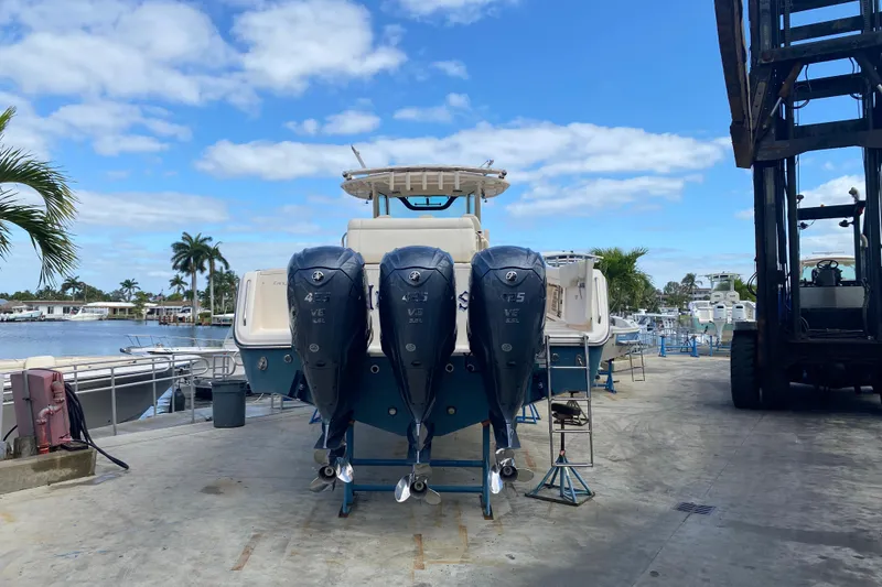 Slide: The Image of 2021 Grady-White Canyon 376 boat with triple outboard engines on a dock. - 29