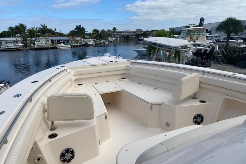 Slide: The Image of 2021 Grady-White Canyon 376 boat interior with spacious seating and waterfront view. - 4