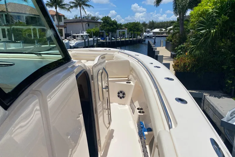 Slide: The Image of 2021 Grady-White Canyon 376 boat docked, showcasing sleek design and spacious deck. - 6