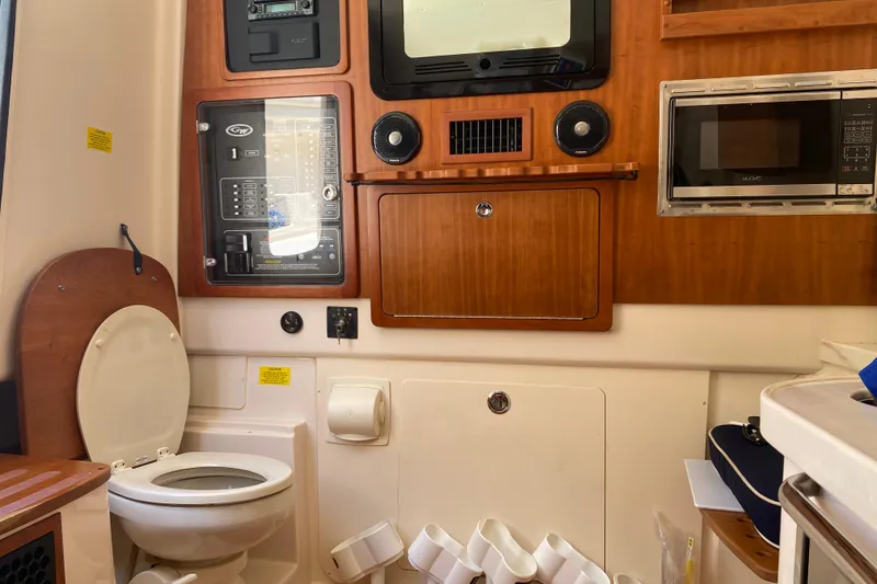 Slide: The Image of Interior of 2021 Grady-White Canyon 376 boat with toilet, control panel, and microwave. - 7
