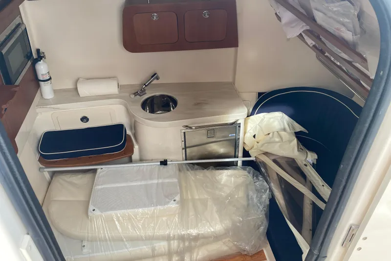 Slide: The Image of 2021 Grady-White Canyon 376 cabin interior with sink, seating, and storage. - 9