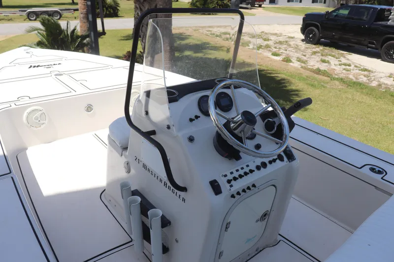 Slide: The Image of 2001 Maverick 21 Master Angler boat console with steering wheel and controls. - 13