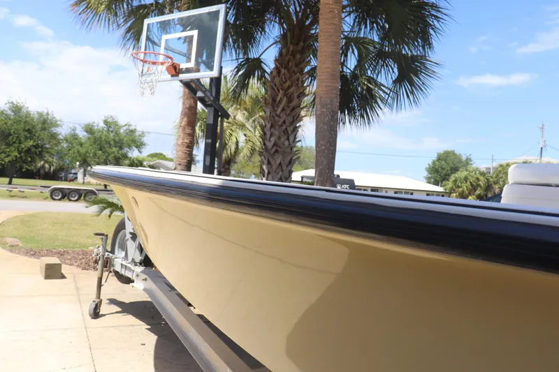 Slide: The Image of 2001 Maverick 21 Master Angler boat on trailer, near palm trees and basketball hoop. - 4
