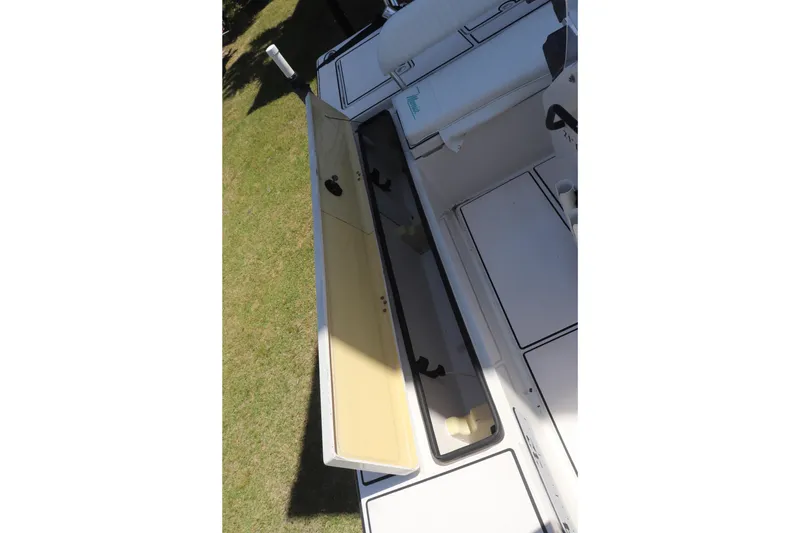 Slide: The Image of 2001 Maverick 21 Master Angler boat storage compartments open, showcasing interior space. - 5