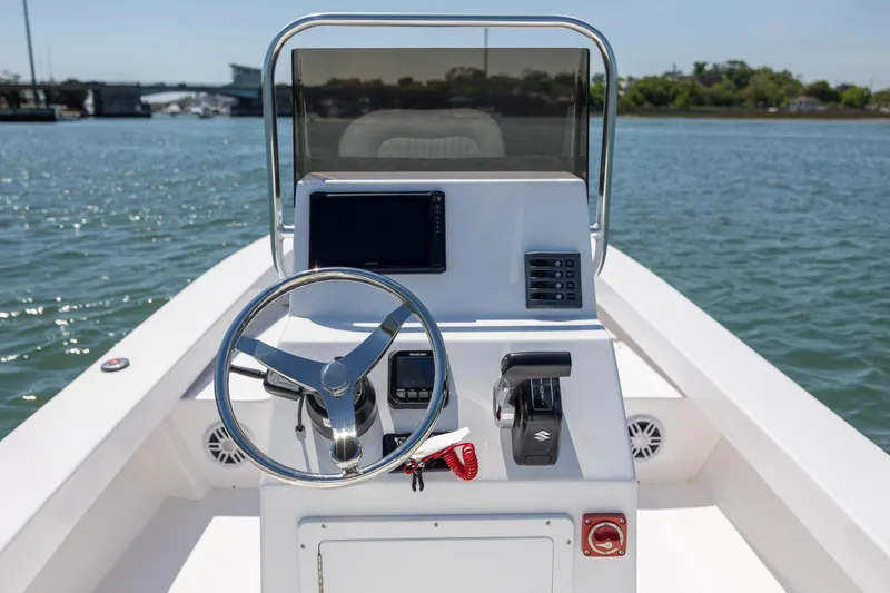 Slide: The Image of StroudCraft 2000 boat dashboard, 2026 model, on calm water with clear sky. - 12