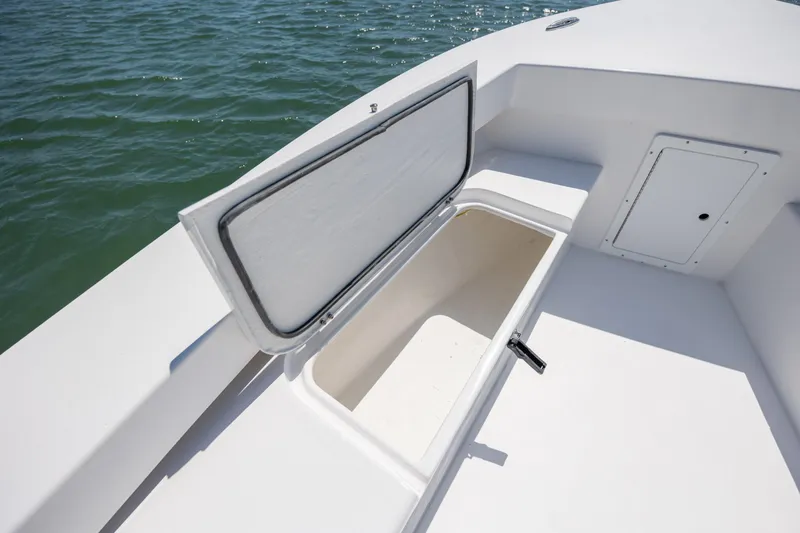 Slide: The Image of Open storage compartment on StroudCraft 2000 boat, 2026 model, with ocean background. - 17