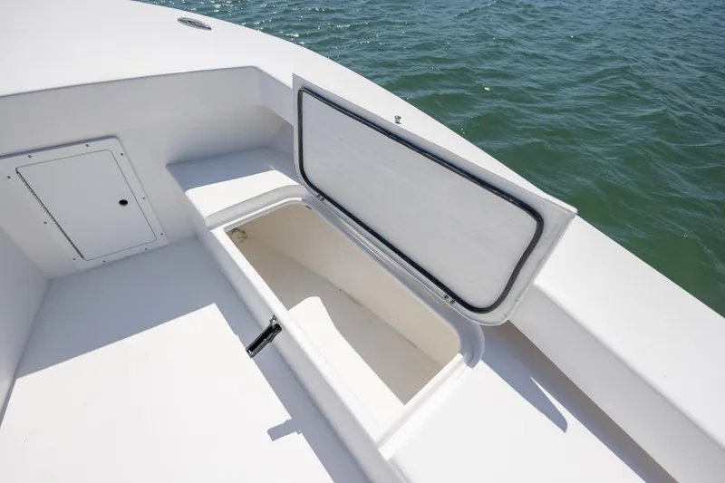 Slide: The Image of Open storage compartment on 2026 StroudCraft 2000 boat, with ocean in background. - 18
