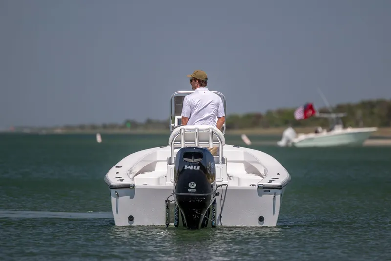 Slide: The Image of Man steering StroudCraft 2000 boat, 2026 model, on calm water. - 2