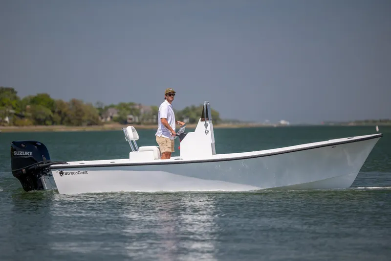 Slide: The Image of A person operates a 2026 StroudCraft 2000 boat on calm waters. - 4