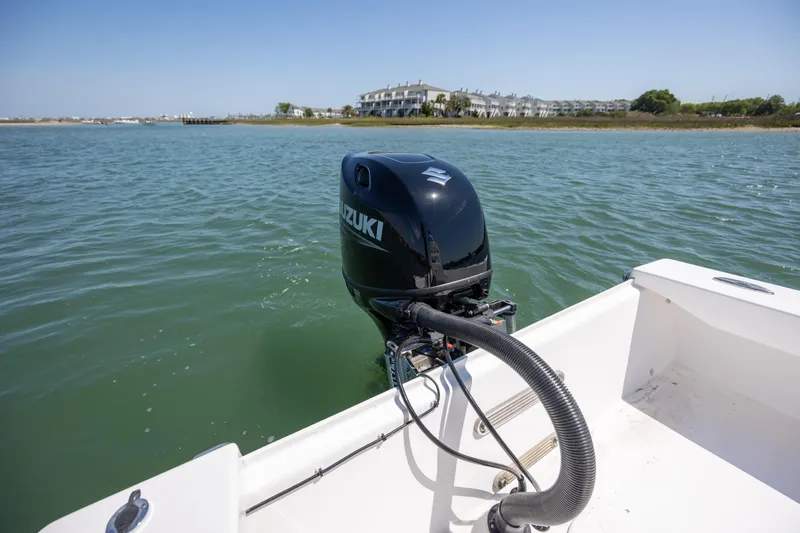 Slide: The Image of StroudCraft 2000 boat with Suzuki outboard motor on calm water, 2026 model. - 7