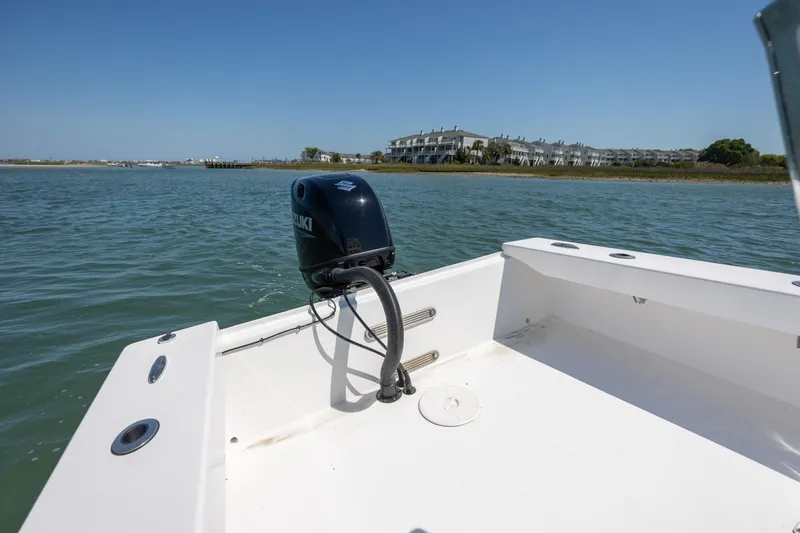Slide: The Image of StroudCraft 2000 boat, 2026 model, with Suzuki outboard motor on calm water. - 8