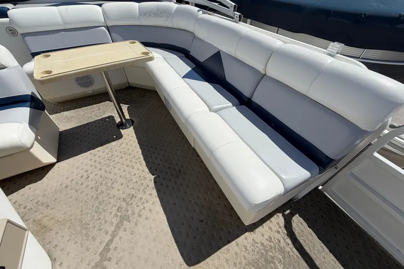 Slide: The Image of 2004 Bentley Pontoons 200 CRUISE interior with white seating and a small table. - 11