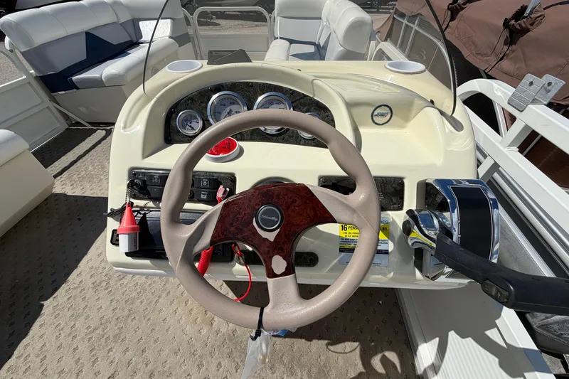Slide: The Image of 2004 Bentley Pontoons 200 CRUISE dashboard with steering wheel and control panel. - 15