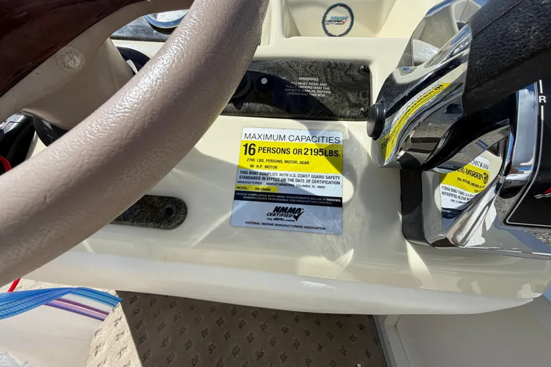 Slide: The Image of 2004 Bentley Pontoons 200 CRUISE capacity label, steering wheel, and controls. - 16
