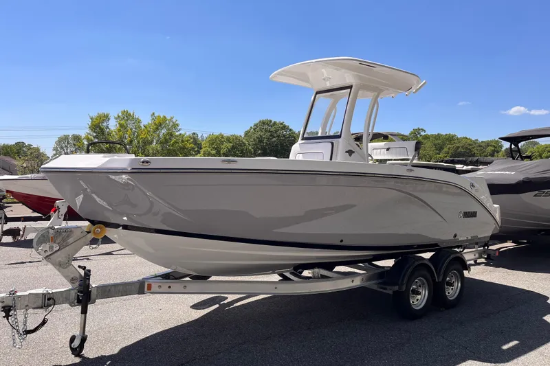 The Image of 2026 Yamaha Boats 222 FSH Sport E on trailer, parked outdoors under clear sky. - 0