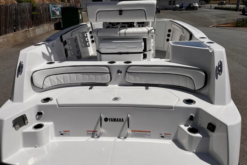 Slide: The Image of 2026 Yamaha Boats 222 FSH Sport E interior, featuring sleek white seating and modern design. - 4