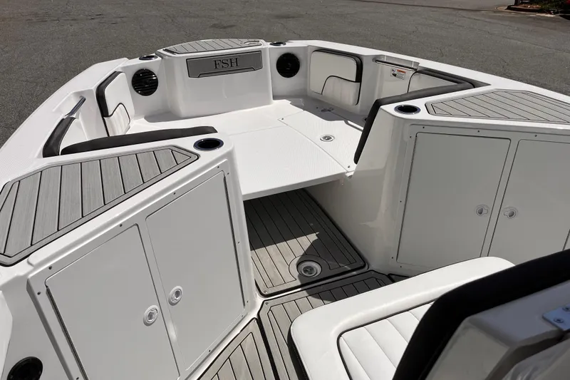 Slide: The Image of 2026 Yamaha Boats 222 FSH Sport E interior with seating and storage compartments. - 9