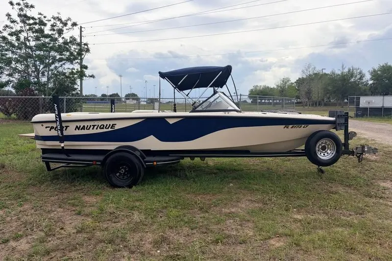 Slide: The Image of 2001 Nautique Sport Nautique 200 boat on trailer, parked on grass. - 2