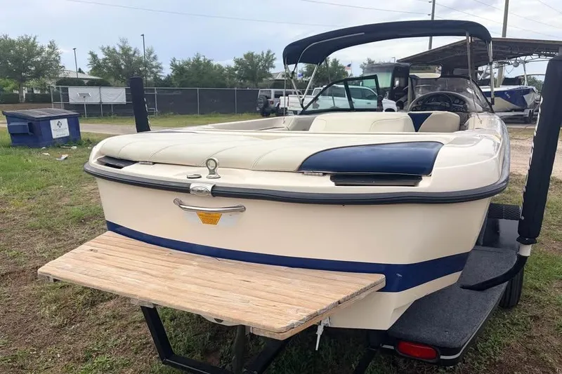 Slide: The Image of 2001 Nautique Sport Nautique 200 boat with swim platform, parked on trailer. - 3