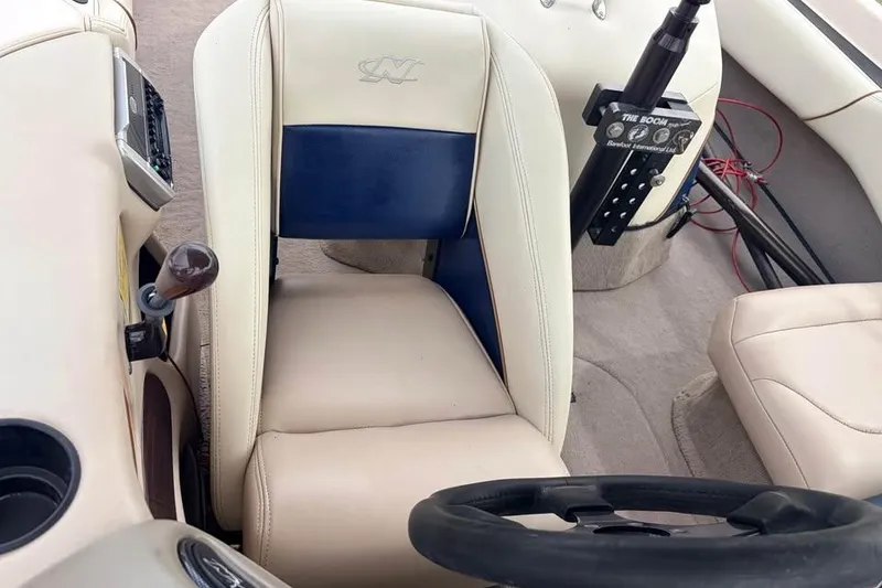 Slide: The Image of Interior of a 2001 Nautique Sport Nautique 200 boat, featuring steering wheel and seating. - 5