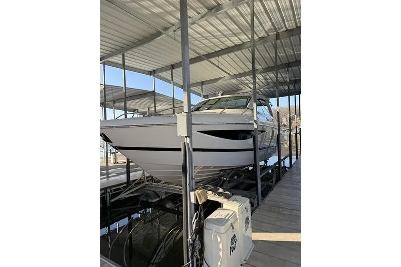 The Image of 2016 Cobalt A40 boat docked in a covered marina slip. - 1