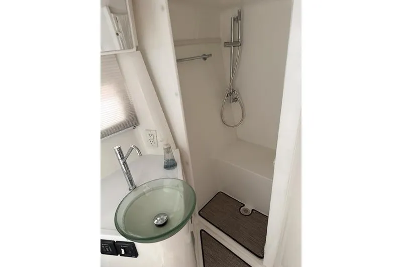 Slide: The Image of Compact bathroom in 2016 Cobalt A40 boat with glass sink and shower. - 11