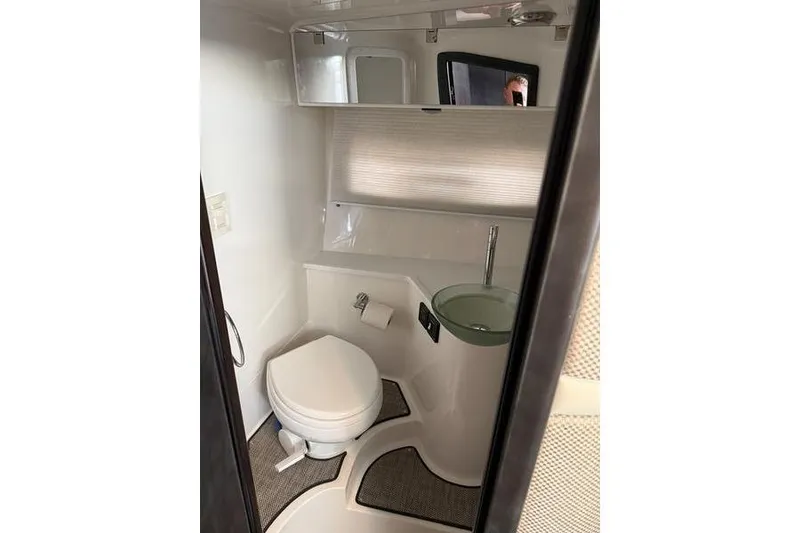 Slide: The Image of Compact bathroom in 2016 Cobalt A40 boat with modern fixtures and sleek design. - 12