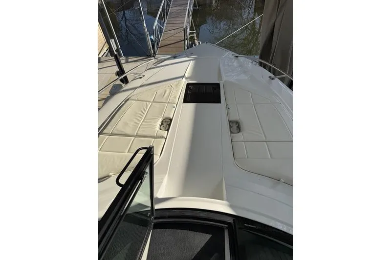 Slide: The Image of 2016 Cobalt A40 boat deck with cushioned seating, docked at marina. - 16