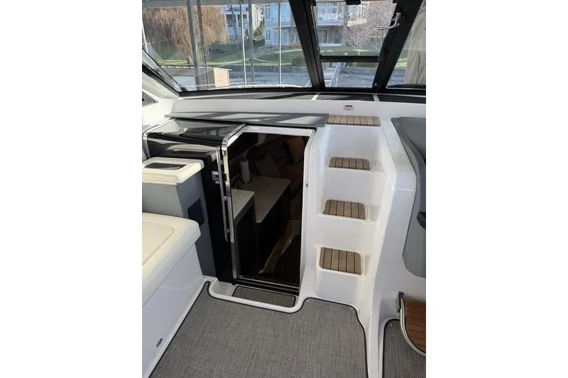 Slide: The Image of Interior view of a 2016 Cobalt A40 boat, featuring stairs and cabin entrance. - 17