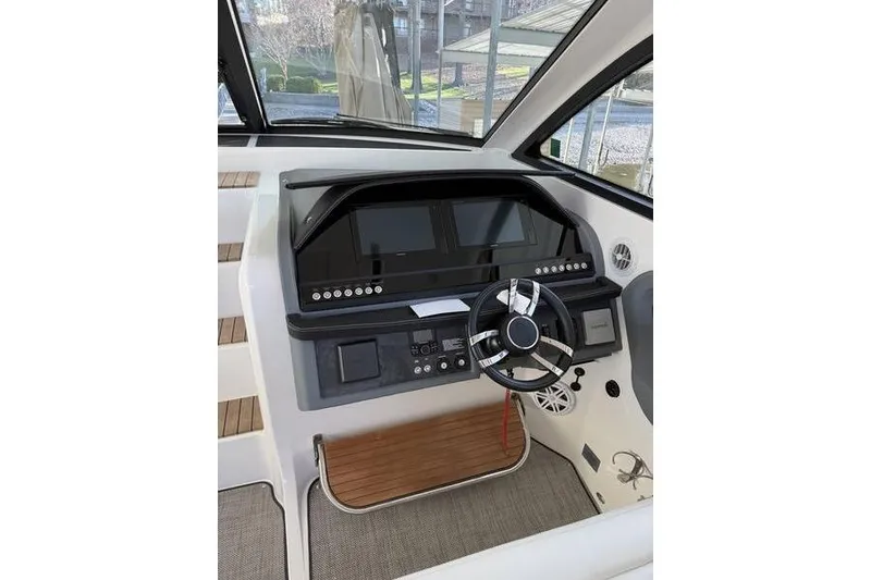 Slide: The Image of Helm of 2016 Cobalt A40 boat with modern controls and steering wheel. - 19