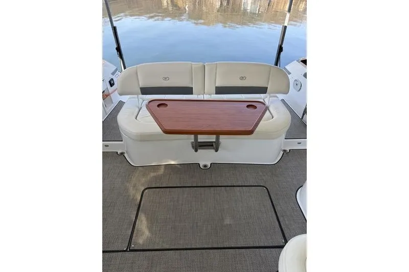 Slide: The Image of Interior of 2016 Cobalt A40 boat with cushioned seating and wooden table. - 22