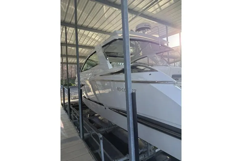 Slide: The Image of 2016 Cobalt A40 boat docked under a metal canopy. - 3