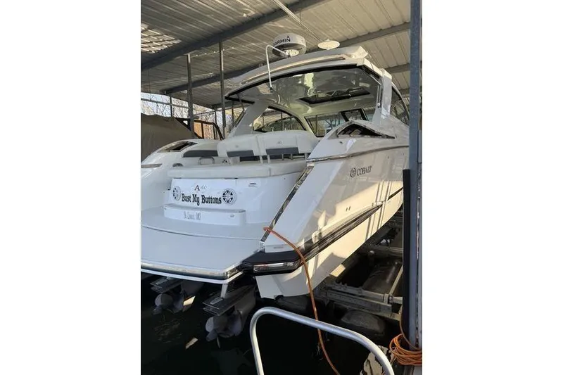 Slide: The Image of 2016 Cobalt A40 boat docked in covered marina, rear view. - 4
