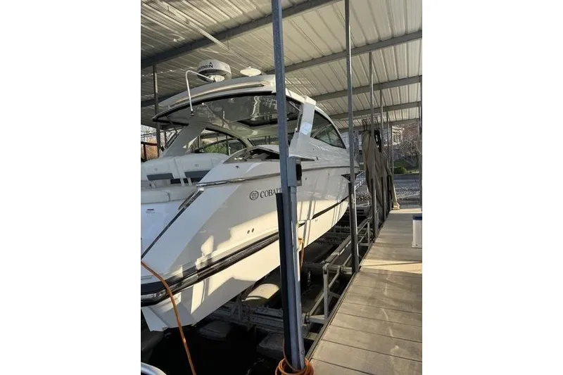 Slide: The Image of 2016 Cobalt A40 boat docked under a covered marina. - 5