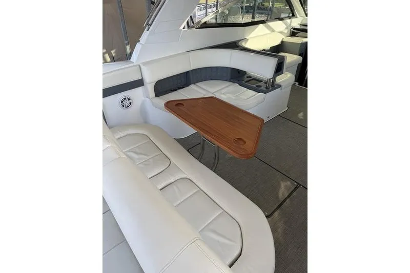 Slide: The Image of Luxurious interior of 2016 Cobalt A40 boat with white seating and wooden table. - 9