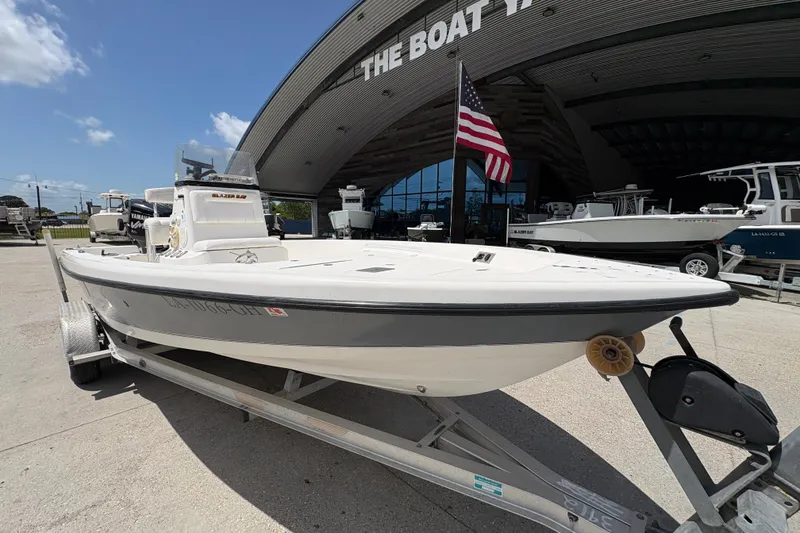 Slide: The Image of 2005 Blazer Bay 2220 Professional boat on trailer outside dealership. - 10
