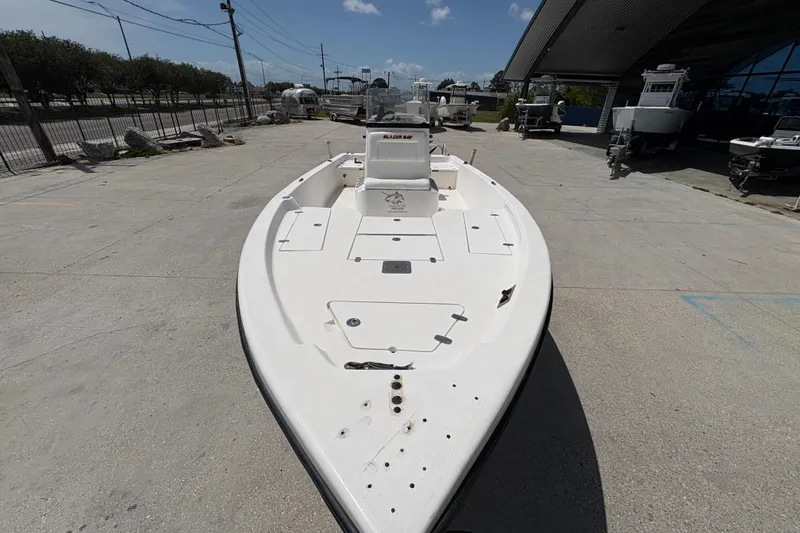 Slide: The Image of 2005 Blazer Bay 2220 Professional boat on display at a marina. - 11