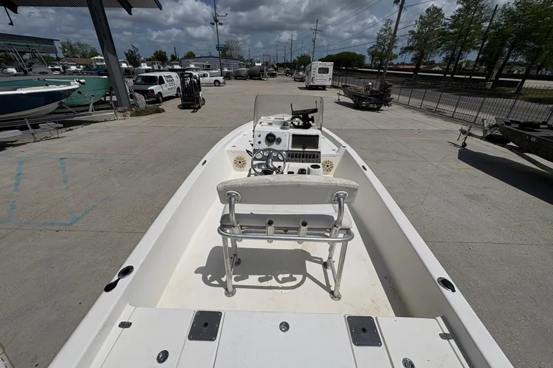 Slide: The Image of 2005 Blazer Bay 2220 Professional boat interior with console and seating, parked outdoors. - 12
