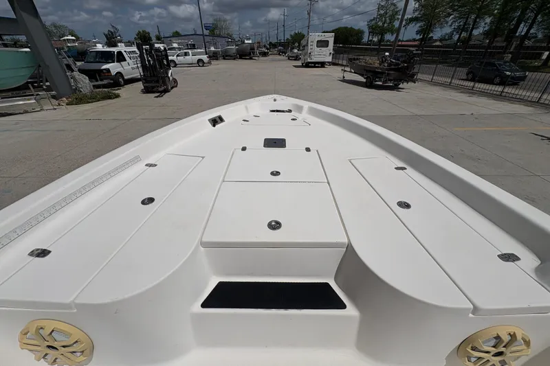 Slide: The Image of 2005 Blazer Bay 2220 Professional boat deck, spacious layout, parked outdoors. - 18