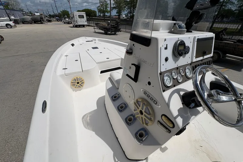 Slide: The Image of 2005 Blazer Bay 2220 Professional boat with steering console and deck view. - 21