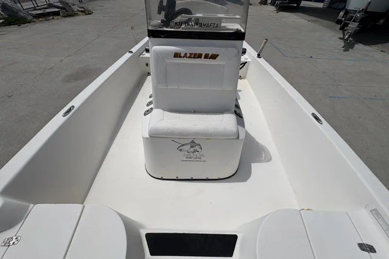 Slide: The Image of 2005 Blazer Bay 2220 Professional boat interior with seating and console. - 22