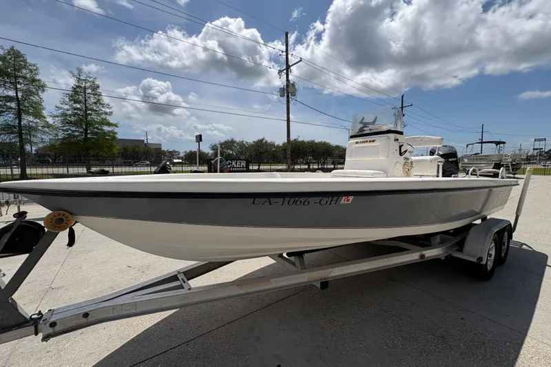 Slide: The Image of 2005 Blazer Bay 2220 Professional boat on trailer under a partly cloudy sky. - 8