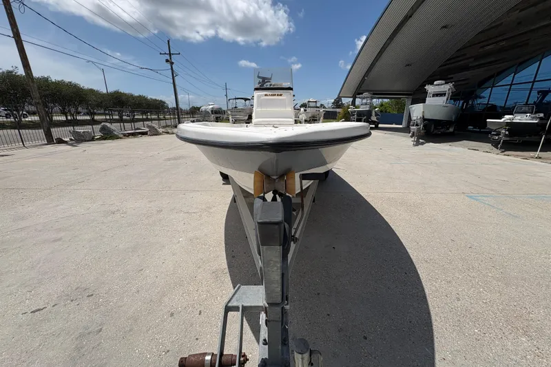 Slide: The Image of 2005 Blazer Bay 2220 Professional boat on trailer, outdoor dealership setting. - 9