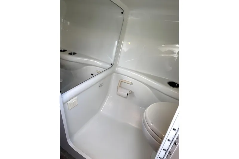 Slide: The Image of 2008 Formula 353 FASTech boat bathroom interior with white fixtures and compact design. - 16