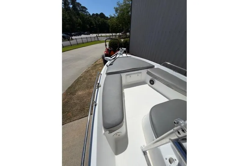 Slide: The Image of 2003 Sea Pro SV2100CC Bay Boat with gray seating, docked outdoors. - 10