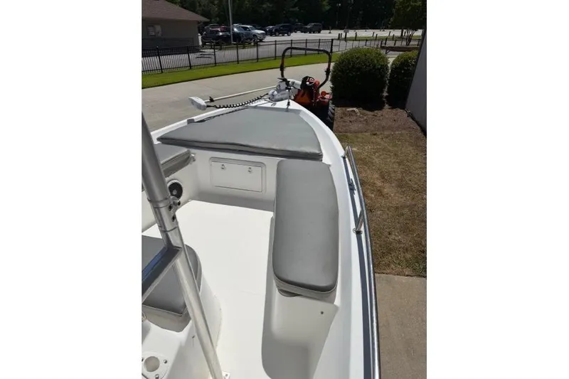 Slide: The Image of 2003 Sea Pro SV2100CC Bay Boat with cushioned seating, parked outdoors. - 11