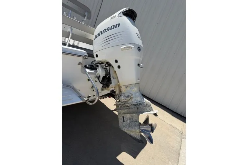 Slide: The Image of Outboard motor on a 2003 Sea Pro SV2100CC Bay Boat, featuring a Johnson engine. - 13